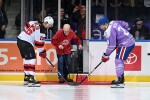 Elderly Man Stepping Onto Hockey Ice Facing Off Against 2 Hockey Players