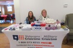 Two Women Sitting at Veterans Crisis Line Support Table